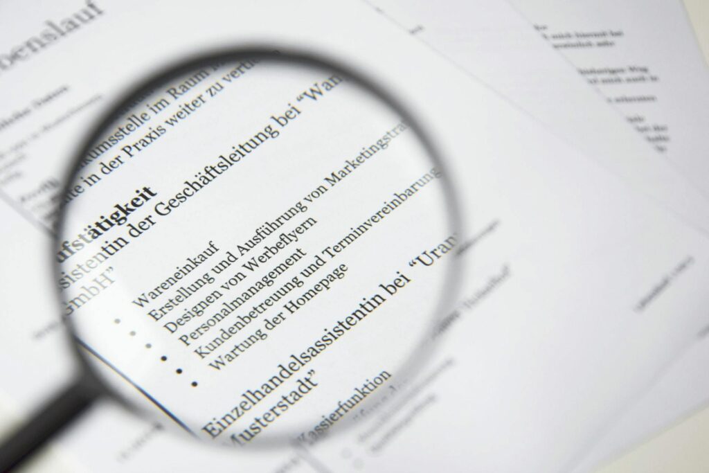 Close-up of a business document text under a magnifying glass.